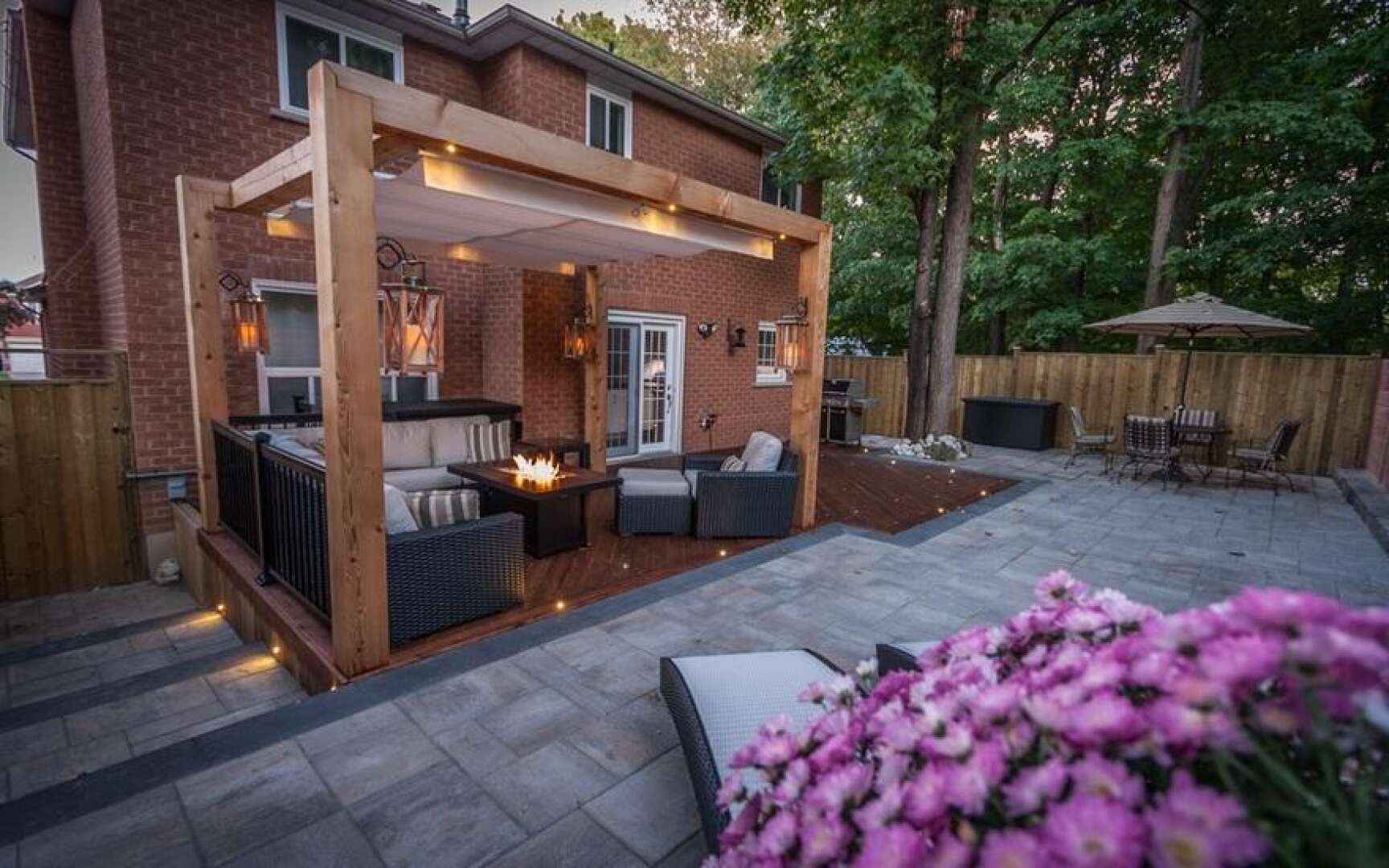 Backyard patio with outdoor seating & lighting