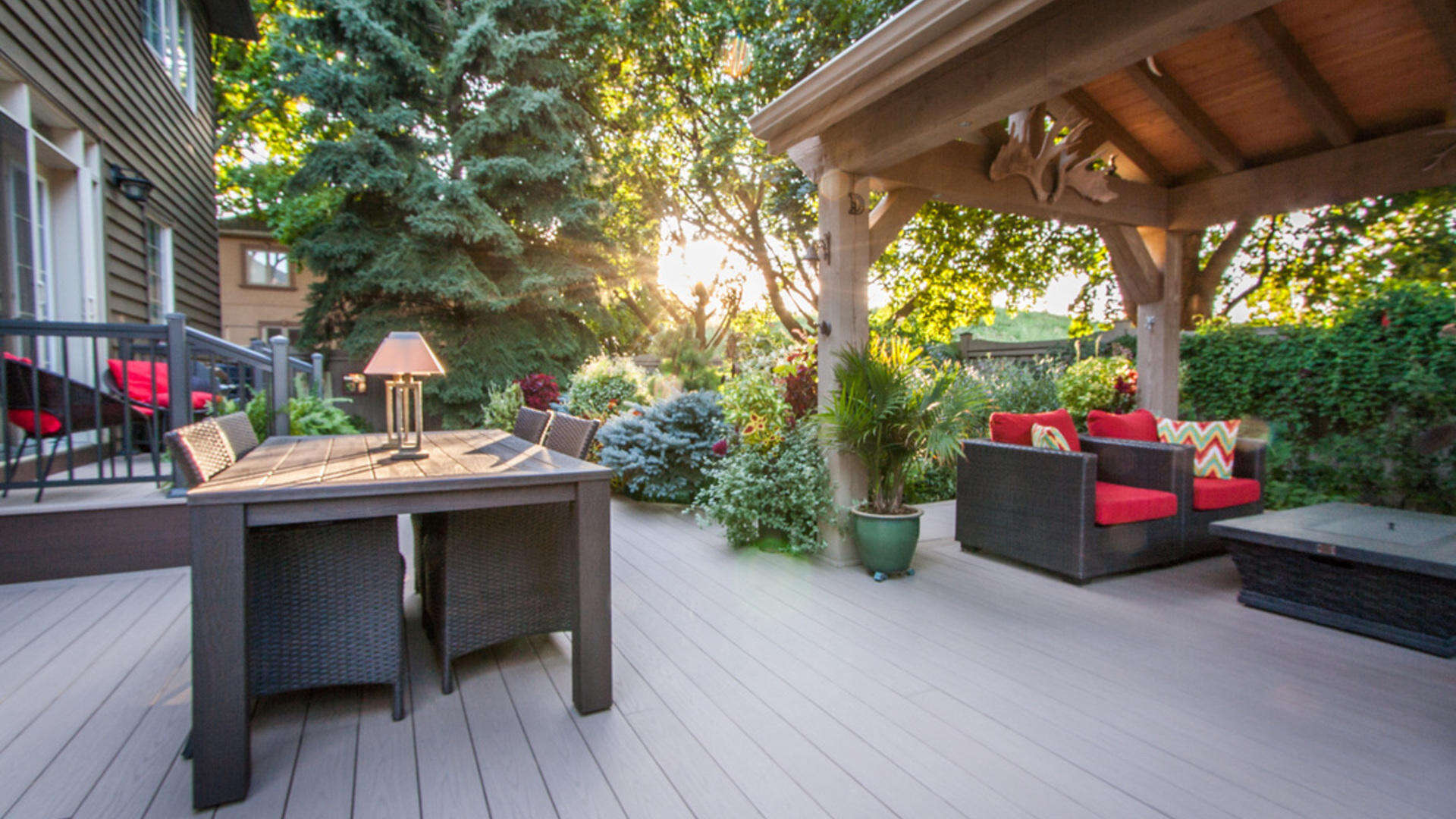 A backyard deck with plants, a table, and a covered seating area in richmond hill