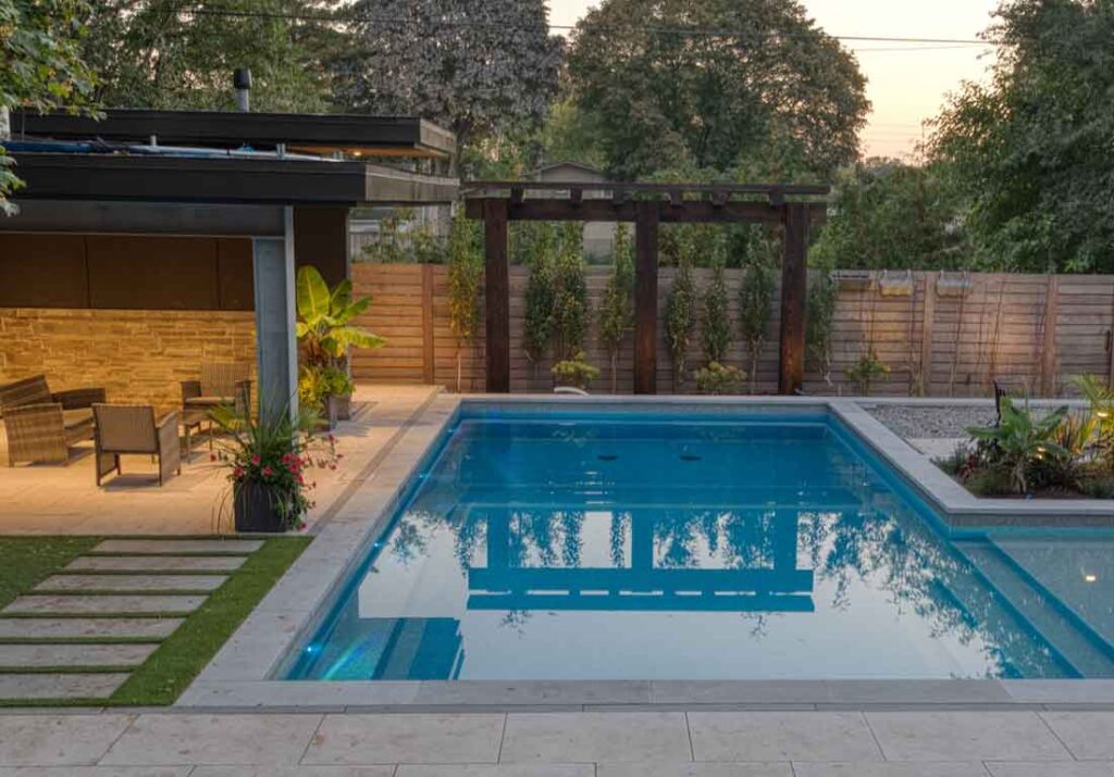 Finished ICF pool in a modern L-shape design with tile lining, featuring a sun deck and shallow kids area