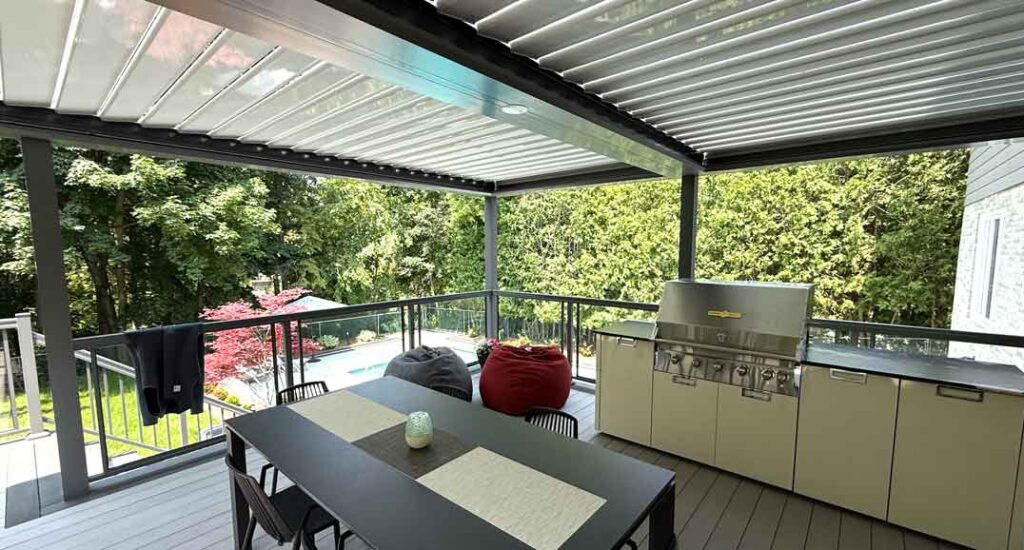 Deck overlooking ravine with a modern louvered pergola providing shade and rain protection