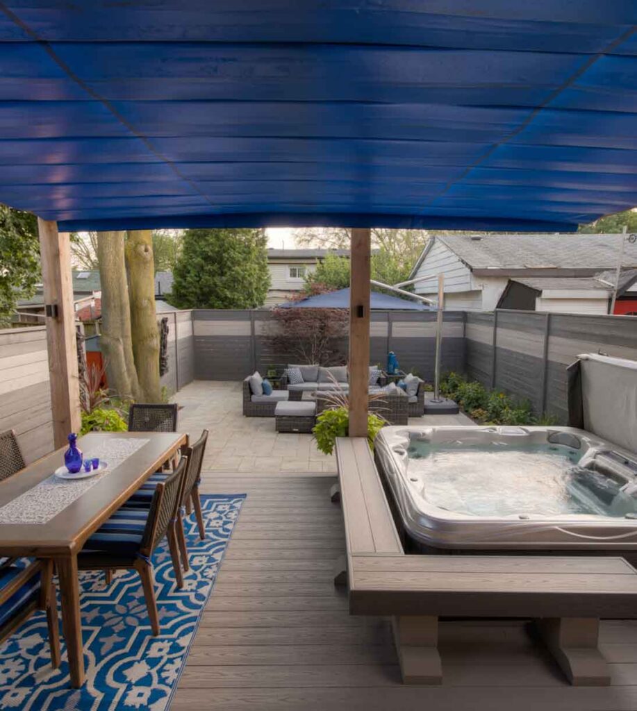 Deck with a pergola and retractable awning system providing shade and rain protection