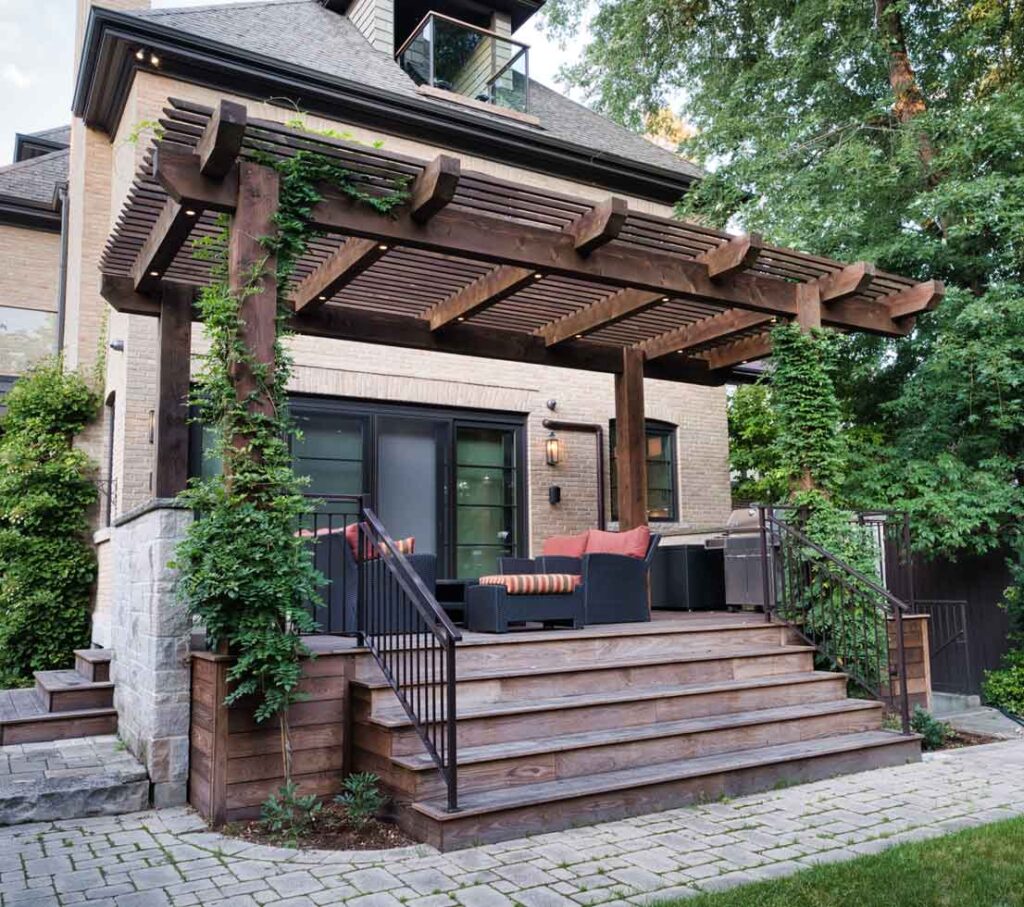 Timber pergola over a backyard deck with ivy providing natural shade and privacy