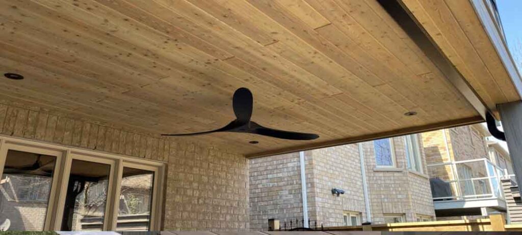 Elevated deck with a waterproofed ceiling creating a dry outdoor living area underneath