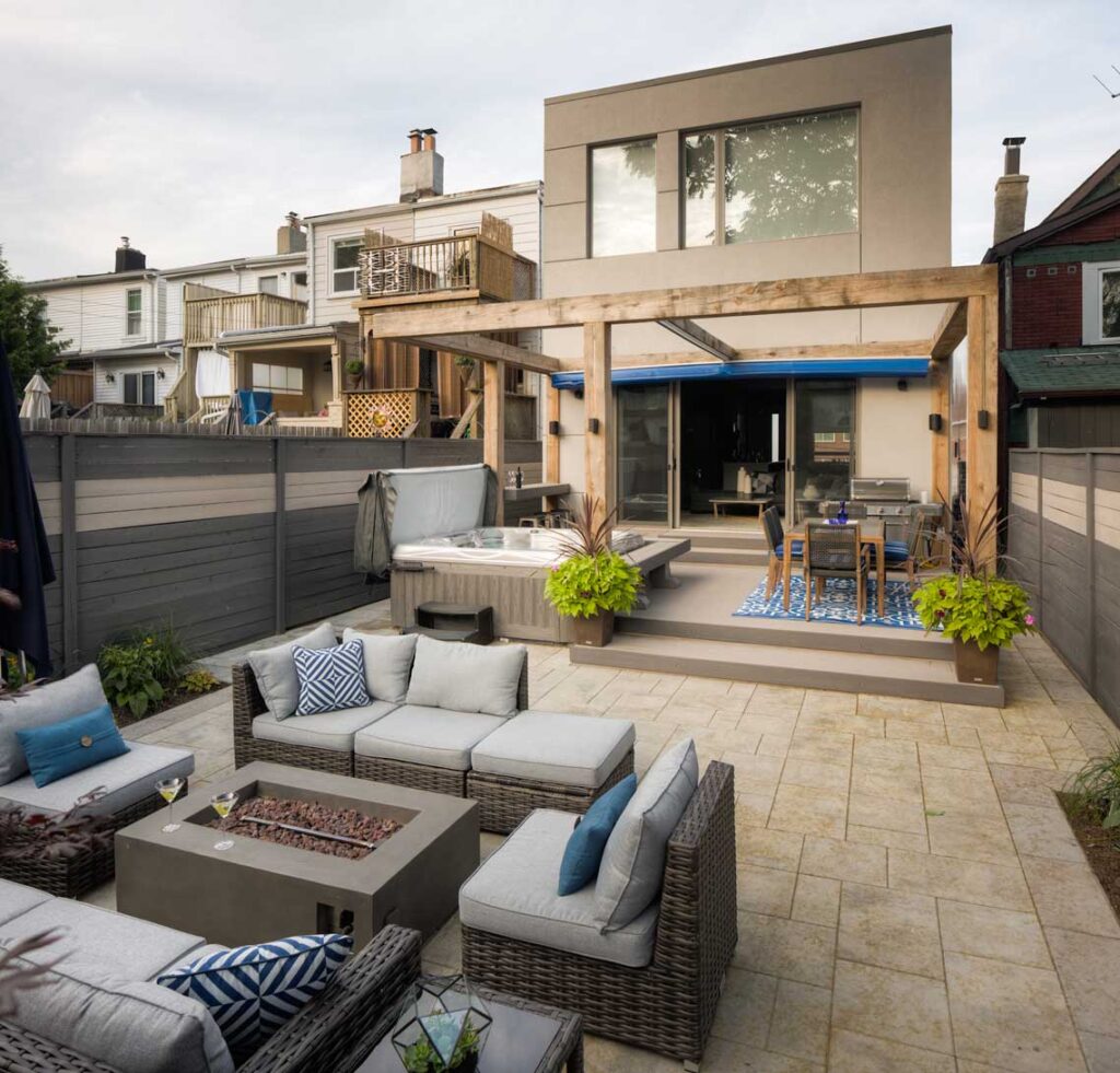 toronto backyard with lanscaped backyard with stone, deck and a retractable pergola
