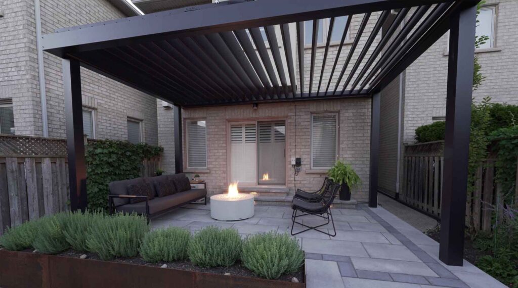 Louvered pergola installed over a stone patio, offering adjustable shade and a solid roof when fully closed