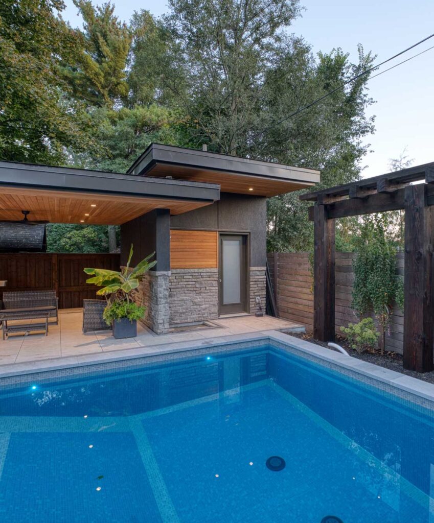 luxury Oakville backyard landscaping with pool and a custom cabana matching house