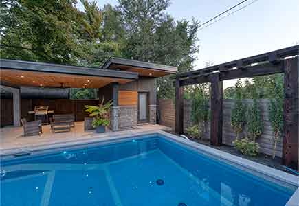 modern back yard created with staycation in mind will pool and caba